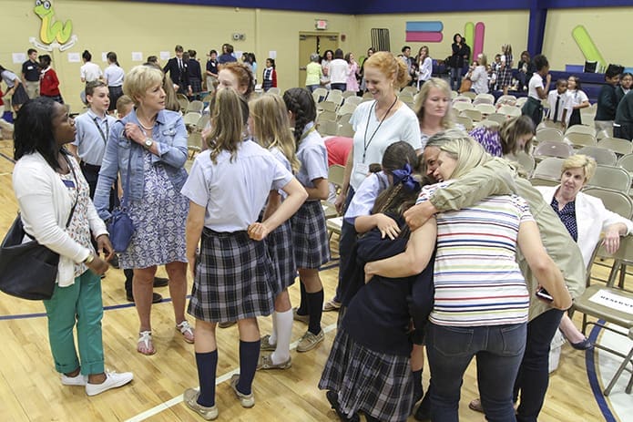 Upon returning from the semifinal competitions, some teams like the third-graders from Queen of Angels School, Roswell, bottom right, received hugs and smiles from elated parents and teachers after sharing the good news of making the finals. Their fifth-grade team also made the finals. Photo By Michael Alexander