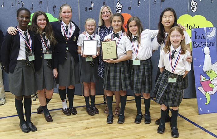 Notre Dame Academy, Duluth, had winners (l-r) among their sixth-grade team, Anissa Ottley, Ashley McDonough Sydney Anderson and Grace Maloney, and their fourth-grade team, Rebecca Murphy, McKenzie Jenny, Anna Grace Bang, and Veronica Kavanaugh. Standing between them in the background is Emily Smolynsky, the school librarian. Photo By Michael Alexander