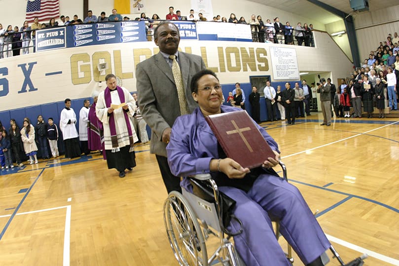 St. Oliver Plunkett Church, Snellville, processes into the St. Pius X High School gym with other directors, each carrying their Book of the Elect. Photo by Michael Alexander