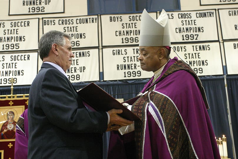 Ed Reinagel of St. Anna Church, Monroe, presents the Book of the Elect to Archbishop Gregory. Photo by Michael Alexander