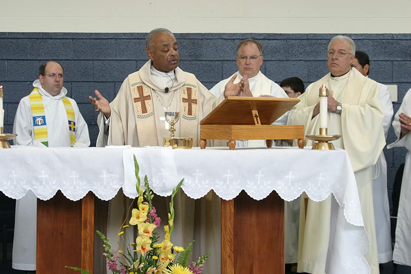 Archbishop Gregory is joined around the altar during the Liturgy of the Eucharist by (l-r) Father Michael Kingery, pastor of St. Clement Church, Calhoun, Father Daniel Stack, pastor of St. Francis of Assisi Church, Cartersville, and Father James Miceli, pastor of St. Mary's Church, Rome. Also present, but not in the photograph was Father Rafael Castano-Fernandez, pastor of St. Bernadette Church, Cedartown. Photo By Michael Alexander