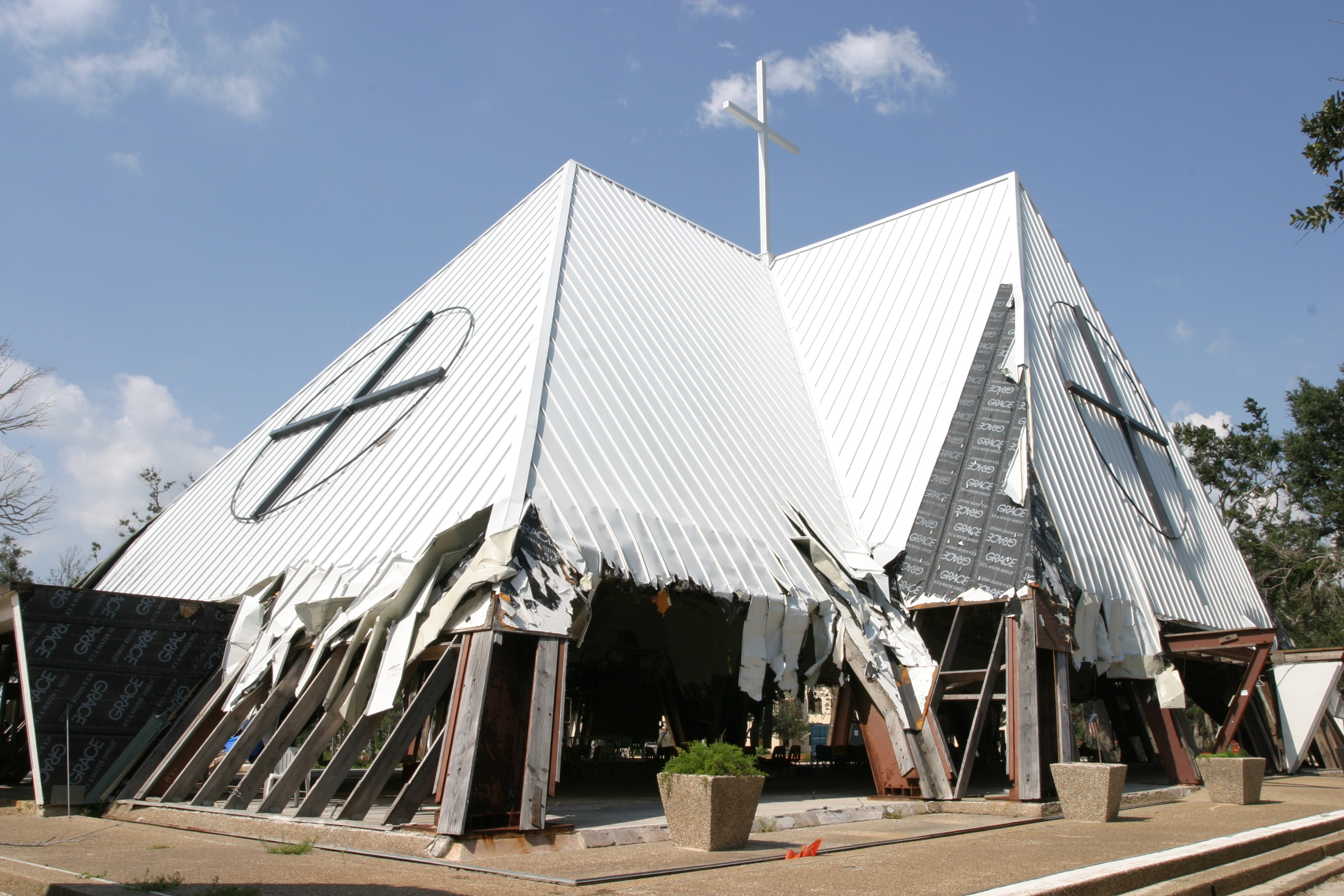 An exterior shot of St. Thomas the Apostle Church, Long Beach, Miss., shows the extensive damage sustained by the Mississippi Gulf Coast parish. Atlanta parishes Immaculate Heart of Mary and St. Jude the Apostle have come to the aid of St. Thomas the Apostle over the past year. Photo By Michael Alexander