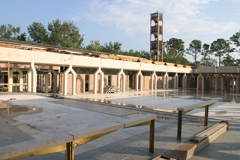 At first glance this looks like it could be a plaza connected to Our Lady of Lourdes Church, Slidell, La., but the large open area was actually the interior of the church. Hurricane Katrina blew off its large, steep pitched roof. The church was a congregation of 1,700 people before the natural disaster. Nearly a year later, this parish of some 900 people is left with an empty shell of a church building. The parish, which has received hurricane relief from various sources, including Holy Cross Church, Atlanta, has a building committee in place to take on rebuilding efforts. Photo By Michael Alexander