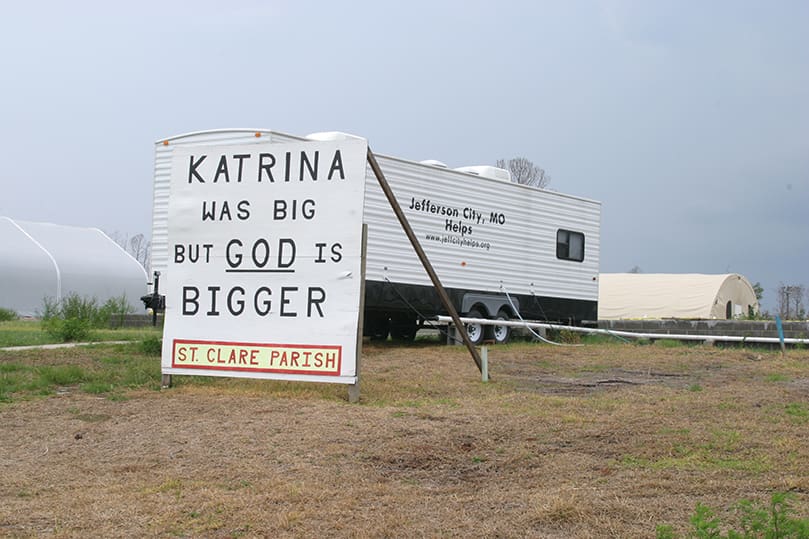 A sign next to the Quonset hut that serves as St. Clare Church, Waveland, Miss., speaks to the steadfast faith of the community. Photo By Michael Alexander