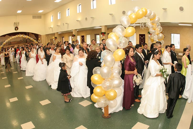 Thirty-one couples gather in the Monsignor William G. Hoffman Social Hall at St. Joseph Church, Dalton, prior to the afternoon celebration of multiple weddings. Photo By Michael Alexander
