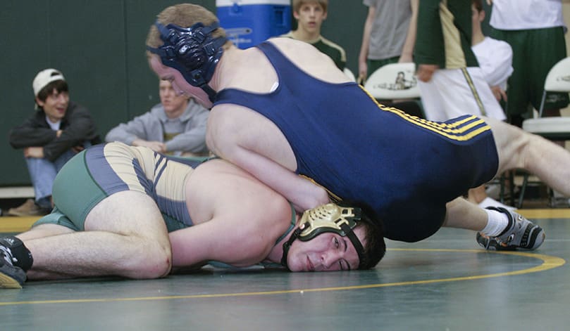Marist freshman Jason Ebinger uses the strength of his athletic frame to hold Blessed Trinity's Adam Vandenberg down during their 160-pound match. Ebinger won the match by a 6-2 decision. Photo By Michael Alexander