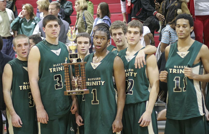Senior guard Jordan Callahan holds the region runner-up trophy. He is joined by teammates (l-r) Tyler Cerone, Ben Kopacka, Sean Cunningham, Kohl Hegetschweiler, Vinny Cuviello and Sean Rouse. It was Blessed Trinity's first trip to the region finals. Photo By Michael Alexander