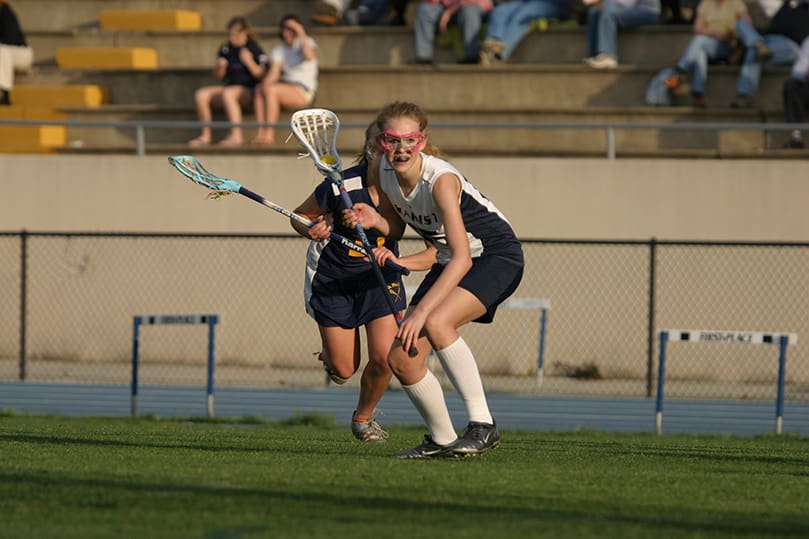 Marist School sophomore Audrey Kaelin, foreground, scored one of the team's nine first period goals. Marist went on to defeat St. Pius X High School 12-6. Photo By Michael Alexander
