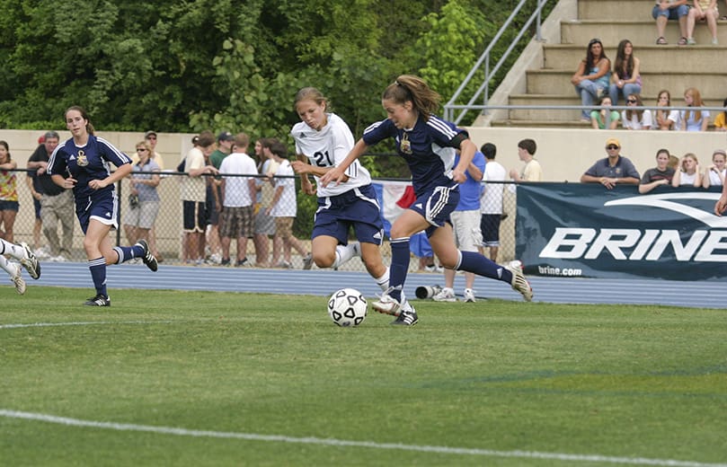 Marist School midfielder Kristen Meier (#21) chases St. Pius X High School forward Alex Newfield as she advances the ball. Newfield scored Pius' only goal in the May 10 match during regulation. Photo By Michael Alexander