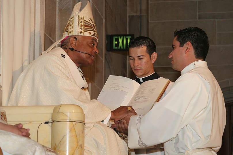 Ignacio Morales, right, pledges his obedience to Archbishop Wilton D. Gregory and his successors. Photo By Michael Alexander