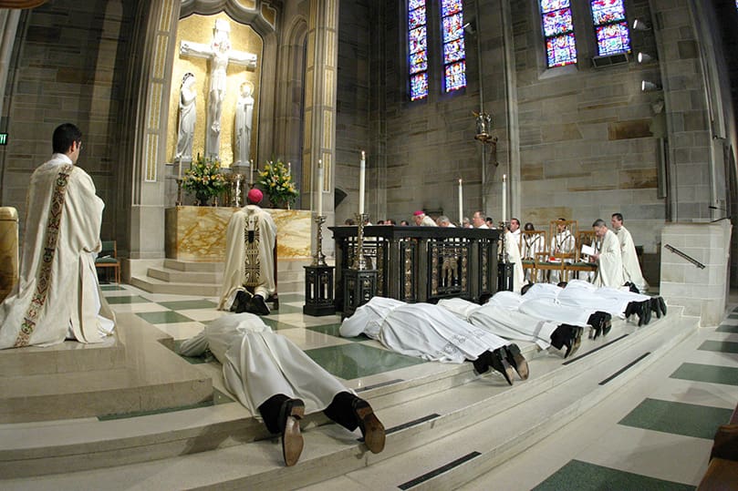 Six young men lay prostrate in the sanctuary of the Cathedral of Christ the King, Atlanta, as the Litany of the Saints is sang during their May 24 transitional diaconate ordination. Photo By Michael Alexander