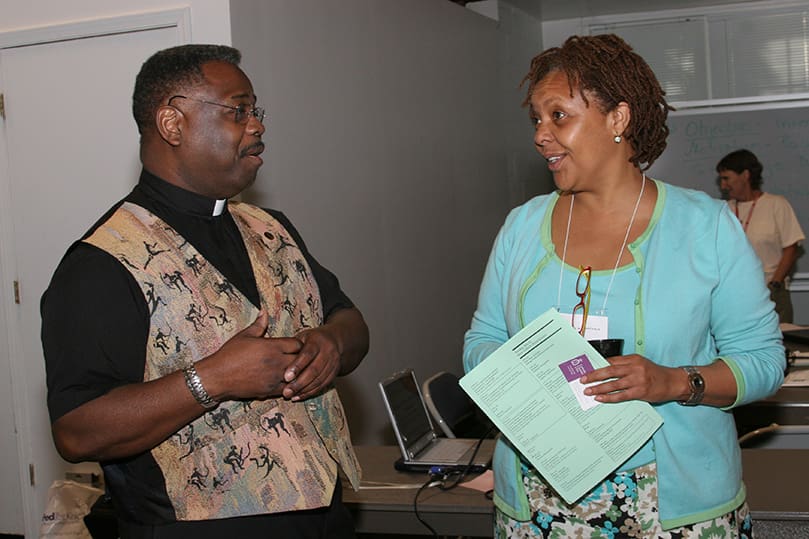 Society of the Precious Blood priest Father Clarence Williams,  left, talks with Pamela K. Anderson of Catholic Relief Services' U.S. Operations group, Baltimore, Md., over a break. Father Williams led a session entitled “Developing A Pastoral Response To Racism” on July 22, where he introduced methodology from his book, Racial Sobriety. Photo By Michael Alexander