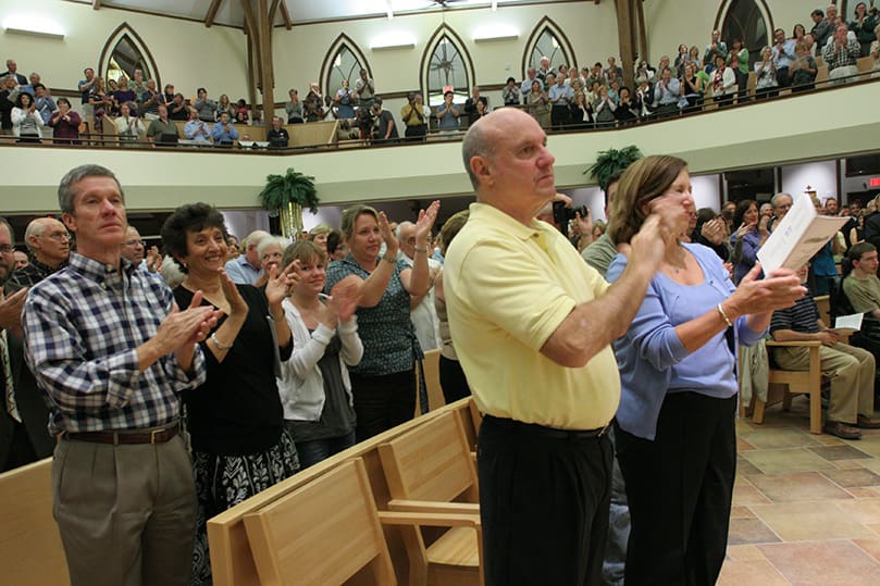 Church of St. Ann parishioners applaud the pastor's efforts in leading the parish through the renovation project. Photo By Michael Alexander