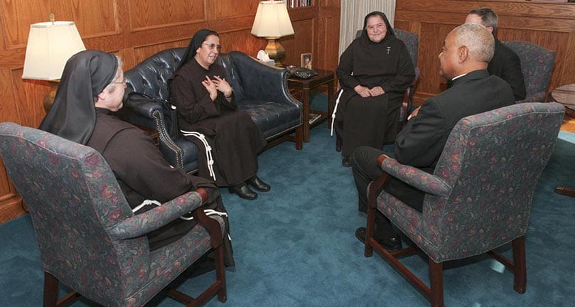Archbishop Gregory welcomes three Franciscan Sisters of Our Lady of Refuge, including the superior general of the 111-year-old order, to his office for a brief meeting. Photo By Michael Alexander