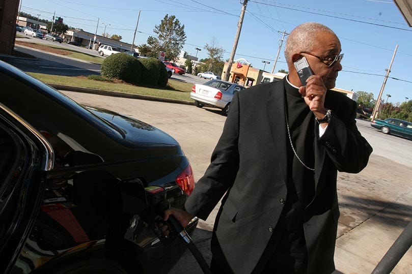 Archbishop Gregory stops to get gas on his way to a dinner engagement with a contingent from of St. Lawrence Church and some other priests. Photo By Michael Alexander
