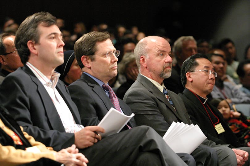 (L-r) Allan Anderson, senior vice president of Dexter Companies, LLC, and Craig Flanagan, vice president of leasing for Duke Realty Corporation, share the front row with Dennis Kelly, project manager for Catholic Construction Services, Inc., and Father Francis Tuan Tran, administrator of the Holy Vietnamese Martyrs Church, Norcross. All four men also shared a common opposition to the propose development of a waste transfer station in their community.