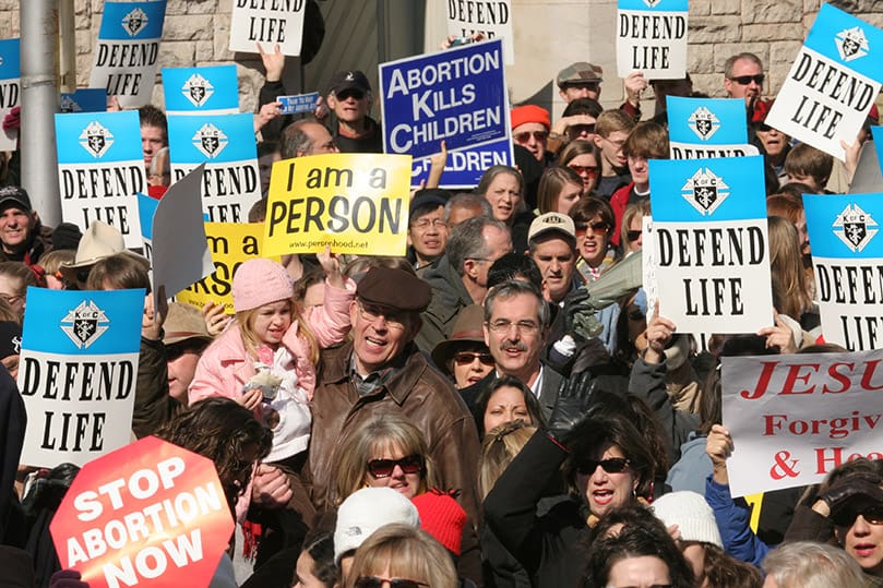 The people in the crowd standing on Washington Street in Atlanta, Jan. 22, wave their signs in support of the unborn. Photo By Michael Alexander