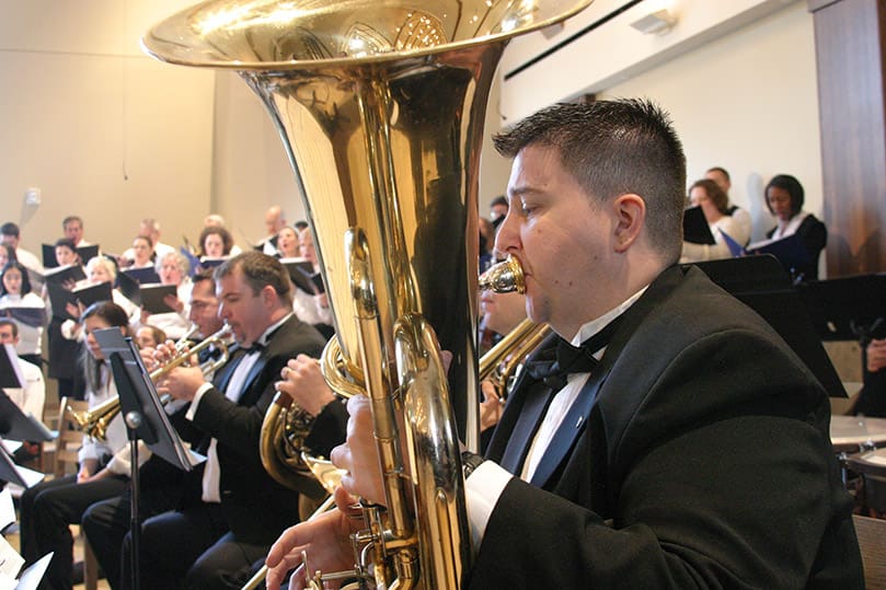 Tuba player Bill Pritchard was one of several musicians accompanying the 60-voice adult and 26-voice school choirs. The musicians and choirs were under the direction of Jeff Bush, director of liturgy and music and Michael Mullink, associate director of music. Photo By Michael Alexander