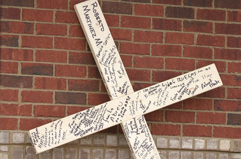The top of the cross bears the name of the Roberto Martinez Medina, a 39-year-old Mexican citizen detainee at the Stewart Detention Center, Lumpkin, who died at St. Francis Hospital, Columbus, on March 11. While the results of an autopsy to determine the cause of death are still pending, questions surround the medical care for Medina and other detainee related deaths. Photo By Michael Alexander
