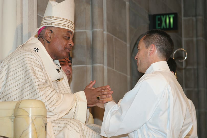 Ordination candidate Thomas Zahuta pledges his obedience to Archbishop Gregory and his successors. Photo By Michael Alexander