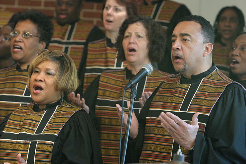 (L-r, across front) Carmelita Rogers, Anne Haas and Eddie Cadres sing in the parish choir. Photo By Michael Alexander
