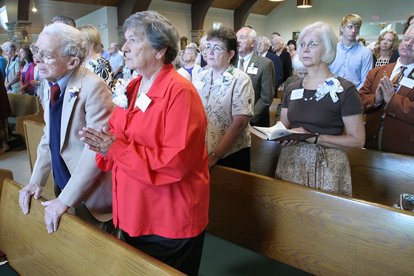 Joseph, front pew, left, and Rosemarie Murray stand among other founding parishioners of Our Lady of the Mountains during a special liturgy marking 25 years since it was first established as a mission and the first celebration of the parish feast, The Holy Name of Mary, Sept. 12. Photo By Michael Ale