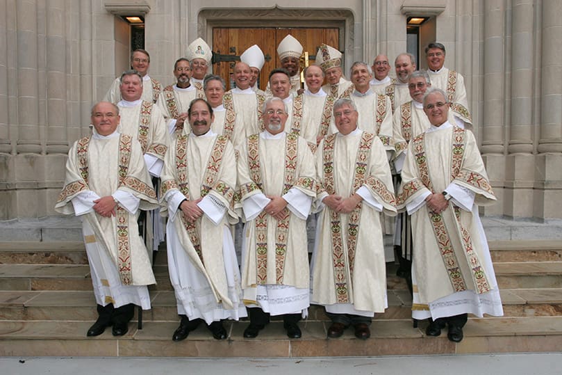 At the ordination's conclusion the Archdiocese of Atlanta's 15 newest permanent deacons take a photograph with Deacon Steve Swope, associate director of formation, back row, far left, Deacon Dennis Dorner, director of the permanent diaconate, back row, far right, and the bishops, which included (l-r, back row with miters) Bishop Joseph J. Madera, retired auxiliary bishop of the Military Archdiocese, Bishop Luis R. Zarama and Archbishop Wilton D. Gregory and Archbishop-emeritus John F. Donoghue. Photo By Michael Alexander