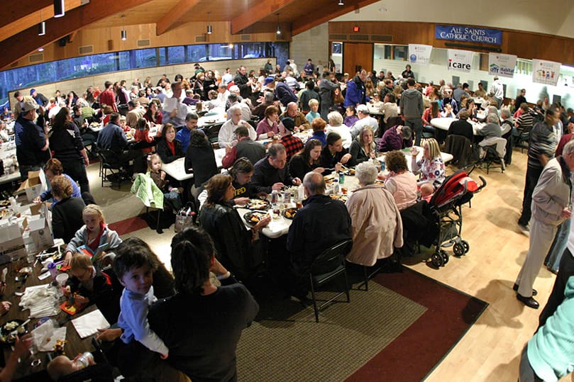 A Friday evening crowd fills the social hall at All Saints Church for the Lenten fish fry. Photo By Michael Alexander