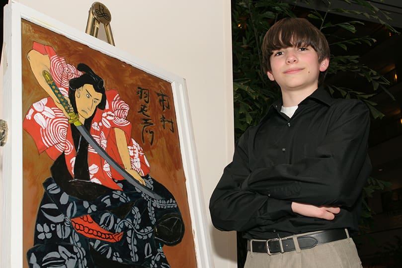 Andrew Jacon stands by his painting of a samurai. Jacon was one of the 31 seventh grade artists from St. John the Evangelist School who participated in the 10th annual Windows Art Exhibit at the Renaissance Concourse Atlanta Airport Hotel, March 5. Photo By Michael Alexander