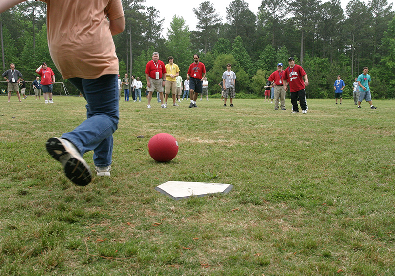 Anna Cuviello of St. Ann Church, Marietta, prepares to put her foot into the oncoming ball as the campers engage in a battle of the sexes kickball game. Photo By Michael Alexander