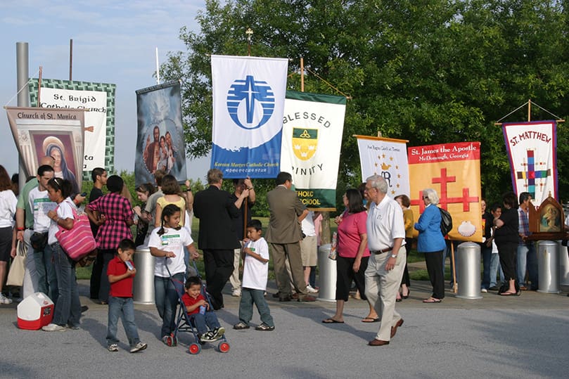 People representing a variety of Catholic Church affiliations gather in preparation for the morning procession. Photo By Michael Alexander