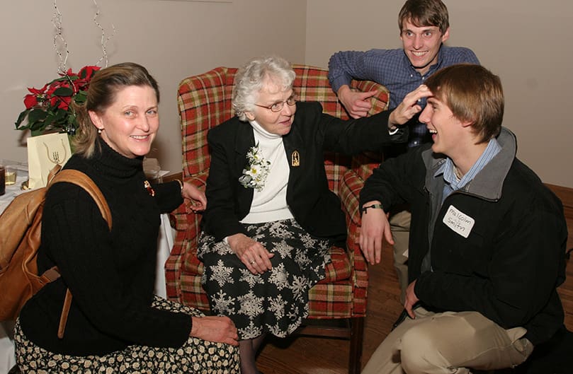 Malcolm, foreground right, and Will Smith get some playful kidding from their great aunt Sister Sally White as their mother Maureen squats down close by. Maureen's mother, Sister Sally's sister, named her after Sister Sally when her religious name was Sister Francis Maureen. Photo By Michael Alexander