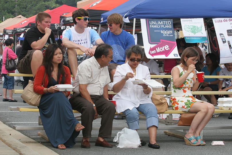 People enjoy the food and entertainment during the June 6 Indonesian Festival, including (bottom row, l-r) Nicky Brown, Hadi and Dewi Trana, Nicky's mother Hanny, (top row, l-r) Nick Ashton, Thomas Bowman and Patrick Eyre. Photo By Michael Alexander