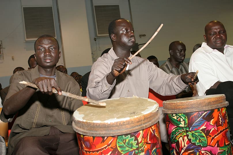 Playing the drums during the responsorial psalm are David Lueth, left, and Jacab Deu. Lueth and Deu came to the United Sates in 2000 and 2001, respectively. Bishop Rudolf Deng Majak, center, was the main celebrant for the June 27 Mass celebrated with the Sudanese community at Corpus Christi Church, Stone Mountain. Concelebrating with him are Auxiliary Bishop Daniel Adwok Kur , left, and Bishop Eduardo Hiiboro Kussala. Photo By Michael Alexander