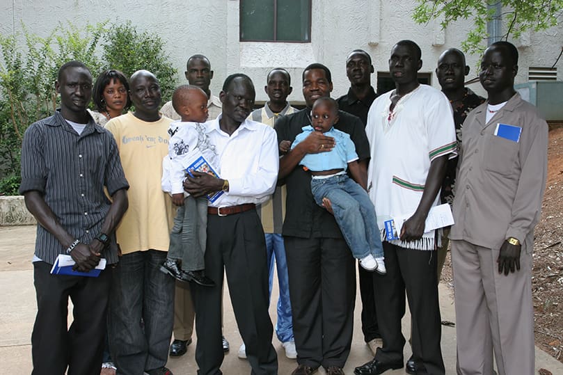 Bishop Eduardo Hiiboro Kussala, third from right holding a child, poses with members of the Sudanese community who arrived in Atlanta between 2000 and 2003. The 40-year-old Bishop Kussala, who was named bishop for the Diocese of Tombura-Yambio two years ago, had the opportunity to reunite with some old acquaintances and friends. Bishop Rudolf Deng Majak, center, was the main celebrant for the June 27 Mass celebrated with the Sudanese community at Corpus Christi Church, Stone Mountain. Concelebrating with him are Auxiliary Bishop Daniel Adwok Kur , left, and Bishop Eduardo Hiiboro Kussala. Photo By Michael Alexander