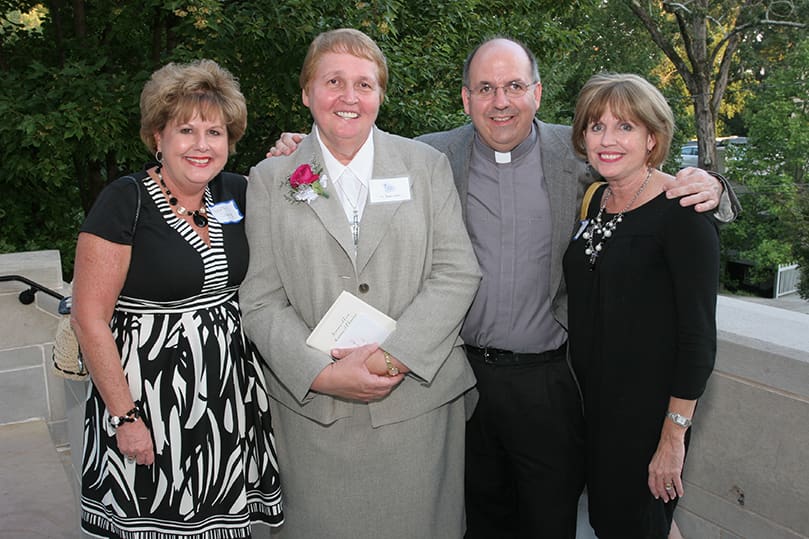 Grey Nun of the Sacred Heart Sister Dawn Gear, second from left, poses with (l-r) Collette Sherry and her siblings Father Michael Kingery, pastor of Holy Trinity Church, Peachtree City, and Karen McConnell. Their other brother, Father Patrick Kingery, was educated for 12 years by the Grey Nuns. Photo By Michael Alexander