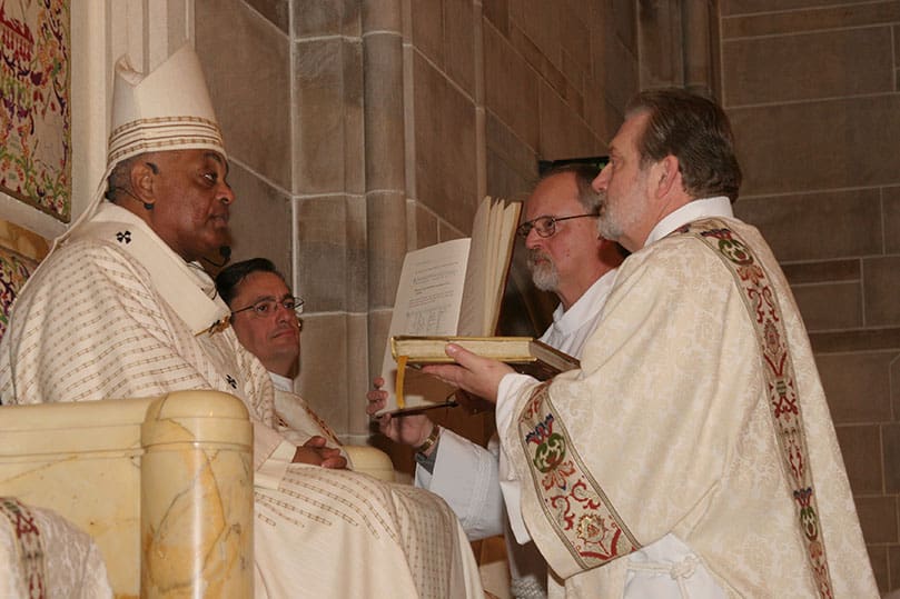 Archbishop Gregory presents the Book of Gospels to Deacon Richard Carl Peter Kaszycki. Deacon Kaszycki is assigned to serve at St. Stephen the Martyr Church, Lilburn. Photo By Michael Alexander