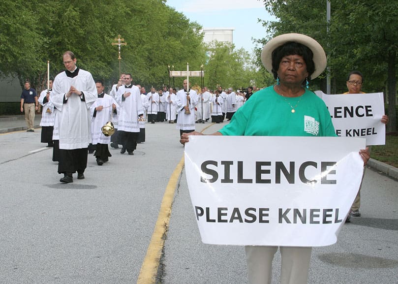Mae Barron of Sts. Peter and Paul Church, Decatur, foreground right, joins a contingent of sign bearers at the front of the eucharistic procession. Photo By Michael Alexander