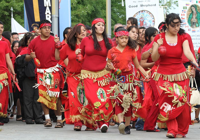 Dancers from St. Clement Church, Calhoun, make their way toward the Georgia International Convention Center during the June 25 procession. Photo By Michael Alexander