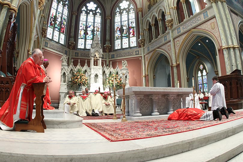 Bishop-elect Gregory John Hartmayer prostrates himself before the altar during the Litany of the Saints. Photo By Michael Alexander