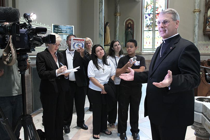 Bishop-elect Gregory John Hartmayer, right, addresses the media during a morning press conference four hours before his episcopal ordination and installation as Savannah’s 14th bishop. Photo By Michael Alexander