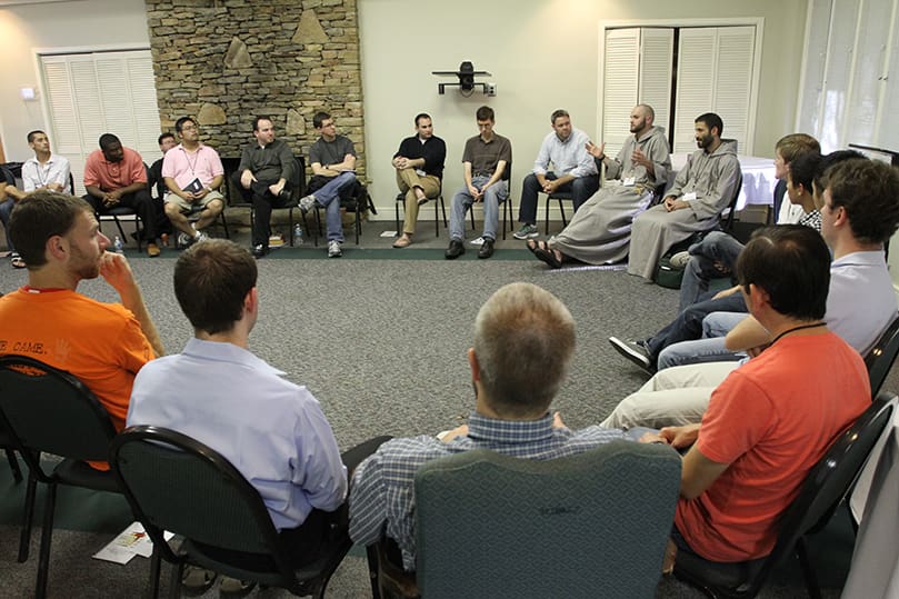 Young men gather in a large circle during the menâs breakout session, where a discussion was led by Franciscan Friars of the Renewal Brother Innocent Montgomery and Father Gabriel Bakkar.