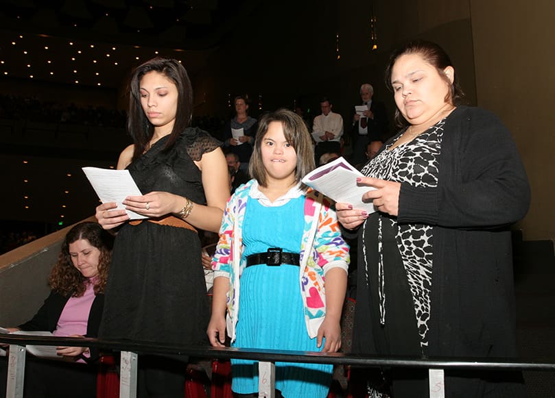 (L-r) Catechumens Mary and Nayomi Caraballo of St. George Church, Newnan, stand with their mother Carmen Oponte. Photo By Michael Alexander