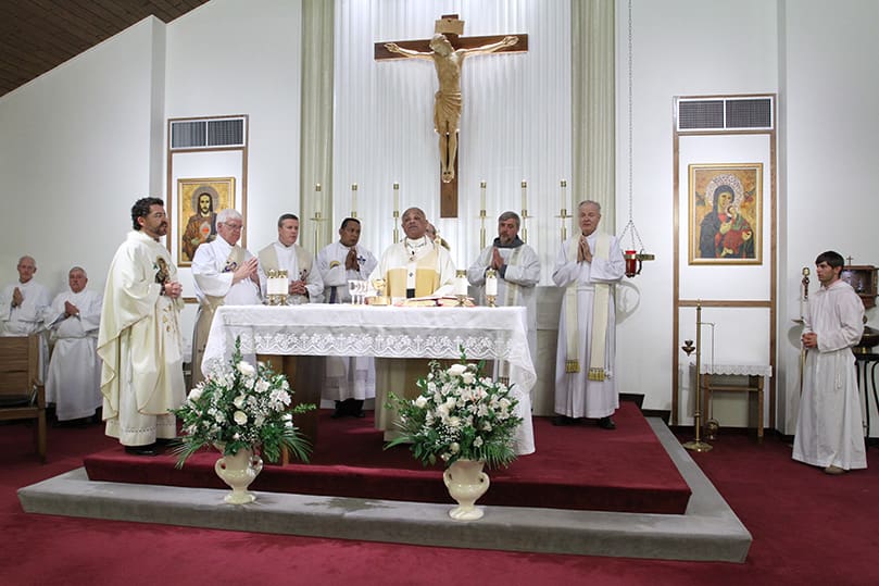 Archbishop Wilton D. Gregory, center, is joined at the altar during the Liturgy of the Eucharist by this brother clergy which included (l-r) current pastor Father Rafael Carballo, Deacon Gary Atkinson of Our Lady of Perpetual Help Church, Father Paul Williams Jr., pastor of Saint Joseph Church, Dalton, Father Juan de Dios Oliveros, parochial vicar at St. Joseph Church, Dalton, Conventual Friar Father Timothy Lyons, parochial vicar at St. John Vianney Church, Lithia Springs, and Father Richard Morrow, the first pastor of Our Lady of Perpetual Help Church. Photo By Michael Alexander