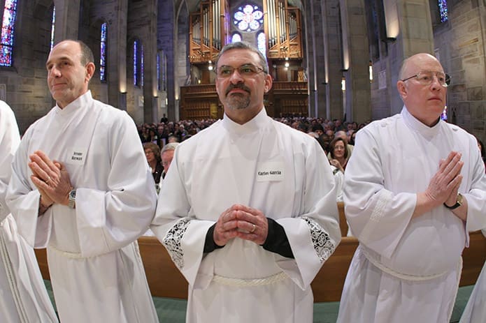 (L-r) Jerome Hayward, Carlos Garcia and Eugene Dickerson stand during the call and presentation of the candidates. They were three of the 12 candidates ordained to the permanent diaconate at the Cathedral of Christ the King. Photo By Michael Alexander