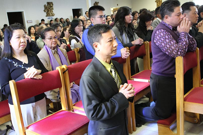 Members of the congregation gather in the sanctuary for the special Dec. 1 Mass marking the elevation of the Holy Vietnamese Martyrs Church from a mission to a parish. Over 1,200 others spilled over into two additional overflow spaces where they watched the service over a live video feed. Photo By Michael Alexander