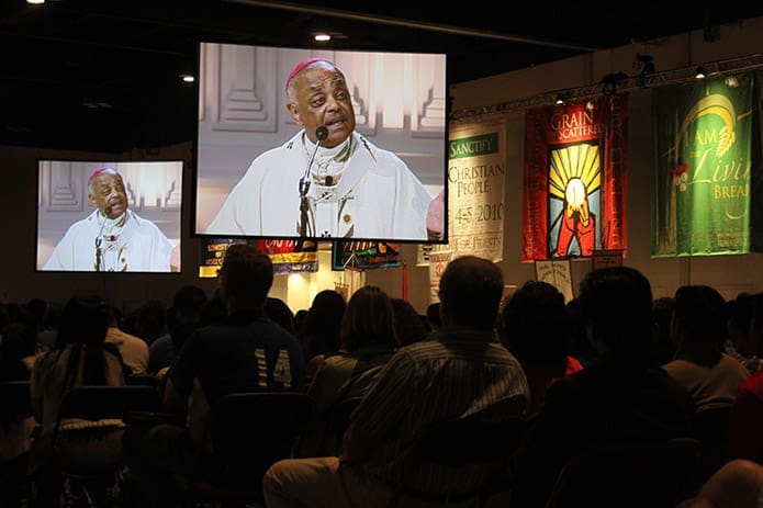 Archbishop Wilton D. Gregory is projected on the jumbo screens around the hall as he delivers his homily during the June 1 vigil Mass.