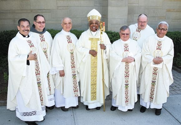 Archbishop Wilton D. Gregory, center, poses with the 2013 silver and golden jubilee priests. They include (l-r) silver jubilarians Missionaries of the Nativity of Mary Father Jaime Molina and Conventual Franciscan Father John Koziol, golden jubilarian Msgr. Frank Giusta, silver jubilarians Father Philip Ryan and Dominican Father Bruce Schultz and golden jubilarian Missionary Society of St. Francis de Sales Father Joseph Mendes. Photo by Michael Alexander