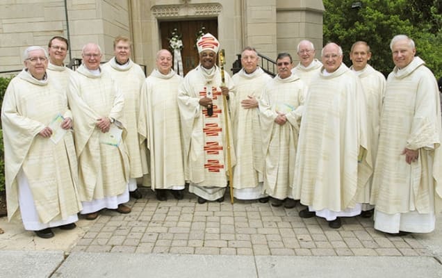 Archbishop Wilton D. Gregory, center, is joined by 11 priests from his May 9, 1973 ordination class on the occasion of their 40th anniversary. All of the priests, except one, are from the Archdiocese of Chicago. Photo by Michael Alexander