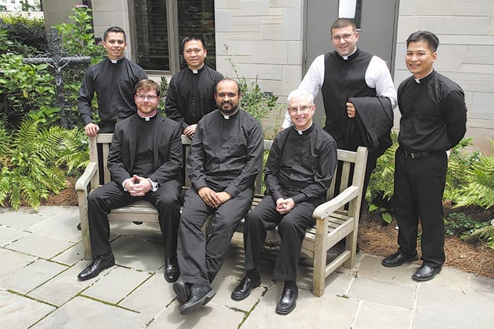 The newest priests in the Archdiocese of Atlanta include (front row, l-r) Dennis Dorner Jr., Gaurav Shroff, Thomas Shuler, (back row, l-r) Feiser Munoz, Cong Nguyen, Michael Revak and Richard Vu. Archdiocesan and visiting priests lay hands upon the seven ordination candidates during their June 8 ordination to the priesthood at the Cathedral of Christ the King, Atlanta. Photo By Michael Alexander